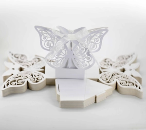 Detail showing white laser-cut butterfly candy box with silk ribbon and flat layout
