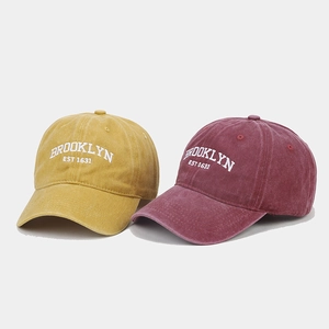 Vintage washed cotton baseball caps with Brooklyn embroidery in mustard yellow and burgundy