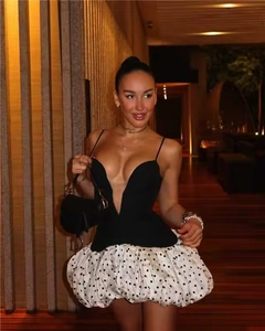 Close-up of deep V-neck camisole top paired with white polka dot bubble skirt