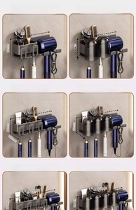 Detail view of wall-mounted gunmetal bathroom organizer with toothbrush and hair dryer holder