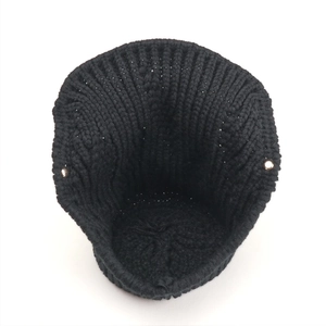 Winter black thick knit brimmed hat with windproof ear protection and metal eyelets