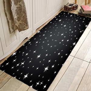 Modern black runner rug with white star pattern on wooden floor in kitchen interior