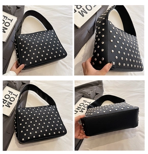 Detail view of black rivet shoulder bag with silver studs and lychee pattern leather