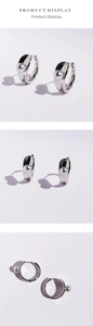 Detailed views of silver hoop earrings with grey pearls and creative heart shadow
