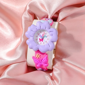 Close-up of a butterfly quartz watch for children on soft pink silk background