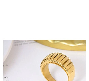 Macro detail of golden croissant ring with elegant vertical textured wave pattern