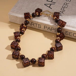 Detail of square leopard print beads and dark brown wooden beads on vintage necklace