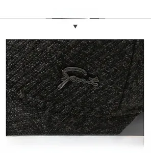 Macro shot of durable black twill fabric and Sport metal logo detail on the baseball cap