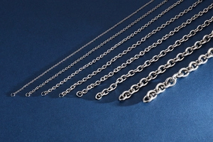 Detail of seven silver stainless steel O-chains and cross chains in varying thicknesses