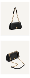 Close-up of black quilted leather crossbody bag with gold chain strap and metal buckle