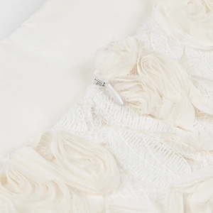 Close-up of 3D chiffon rose applique and invisible zipper on mesh lace dress