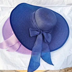 Women's wide brim straw sun hats with ribbon bows in dark blue and light purple