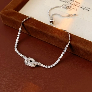 Macro shot of silver adjustable knot bracelet with shimmering cubic zirconia stones