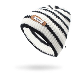 Close-up of the fuzzy knit texture and brown leather label on the striped beanie hat