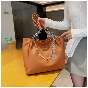 Close-up of brown litchi pattern leather tote with metal chain and leather strap