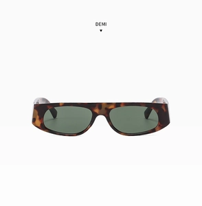 Detailed close-up of demi tortoiseshell frame sunglasses with dark green lenses