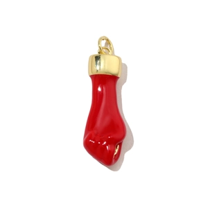 Macro view of a red Figa hand charm with polished gold cap and bail connector