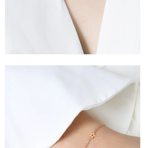 Detail view of rose gold star necklace and bracelet set in minimalist titanium steel