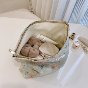 Detail of floral canvas cosmetic bag interior showing storage capacity and zipper