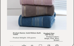Stacked 140x70cm cotton bath towels with gold ribbon detail in pink, gray and blue