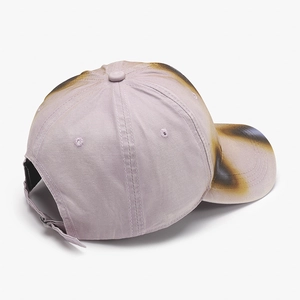 Faded lavender baseball cap with distressed spray-paint effect and adjustable back strap