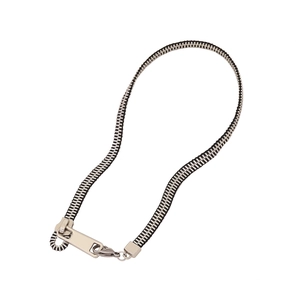 Modern silver zipper necklace with black and metal teeth on a clean white background