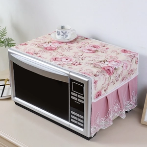 Close-up of pink floral microwave dust cover with white lace edge and pleated fabric detail