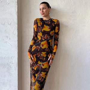 Détail de robe longue fleurie transparente avec manches longues et fente latérale ajustée