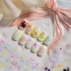 Macro shot of 3D colorful stars and bow nail stickers with pastel press-on nails