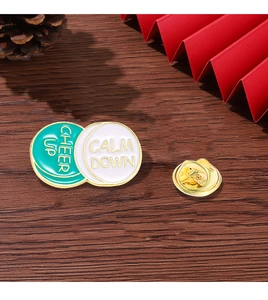 Detail view of round enamel pill badge with butterfly clutch on dark wooden surface