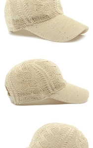 Detailed view of beige knit baseball cap with sequins and texture details