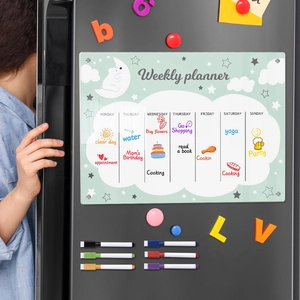 Magnetic acrylic weekly planner on black fridge with six markers and colorful magnets