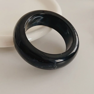 Detailed macro view of heavy resin ring featuring black marble and white sand texture