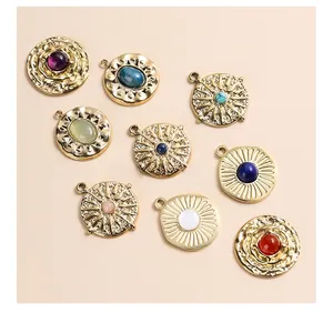 Detailed macro view of vintage hammered round metal pendants with colorful semi-precious stones