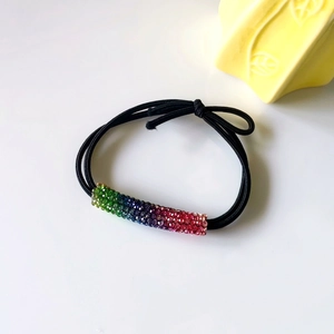 Rainbow rhinestone hair tie with three-strand black elastic band in a stylish design
