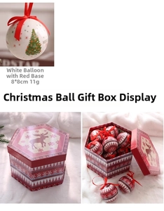 Detail of red and white Christmas ball ornaments with reindeer motifs in a gift box