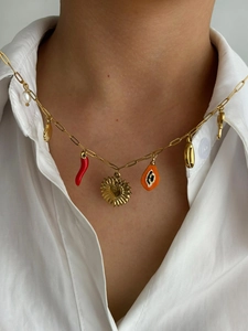 Detail of bohemian gold layered necklace with pearl, red chili and shell charms