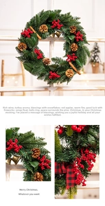 Close-up of Christmas wreath with red berries, pine cones and buffalo plaid bow