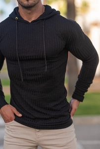 Detail of black muscle fit knit hoodie showing ribbed texture and drawstring hood