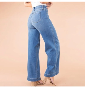 Side view of women's high waist wide leg blue jeans with washed denim texture