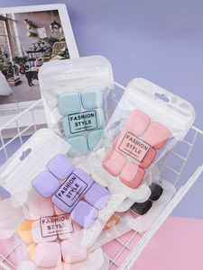 Macro shot of colorful square finger powder puffs set in an elegant display basket