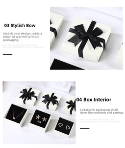 Close-up of white jewelry gift box with black ribbon bow and velvet foam insert