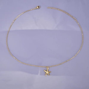Detail view of gold starfish pendant necklace with lobster clasp and adjustable chain