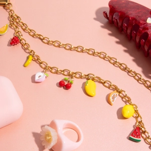 Detail of 18K gold-plated steel chain with colorful enamel fruit charms for bags