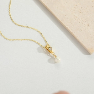 Elegant gold necklace featuring a sparkling zircon accent and a round white pearl pendant