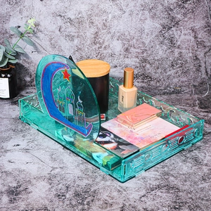 Detail of teal acrylic storage tray with moon and mosque silhouette for organization
