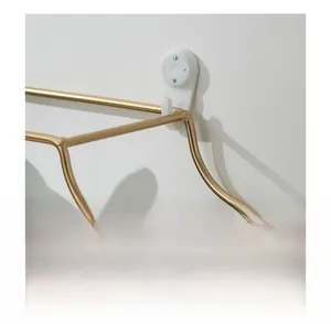 Close-up of golden metal wall shelf showing non-marking nail and easy installation