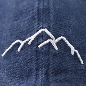 Washed cotton baseball cap featuring white mountain peak embroidery and vintage texture