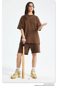 Deep brown retro street style outfit with oversized t-shirt and drawstring shorts