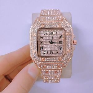Detail view of rose gold square watch with full diamond setting and Roman numerals